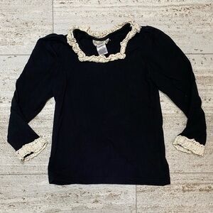 Sado girl’s black shirt w/beige details.‎